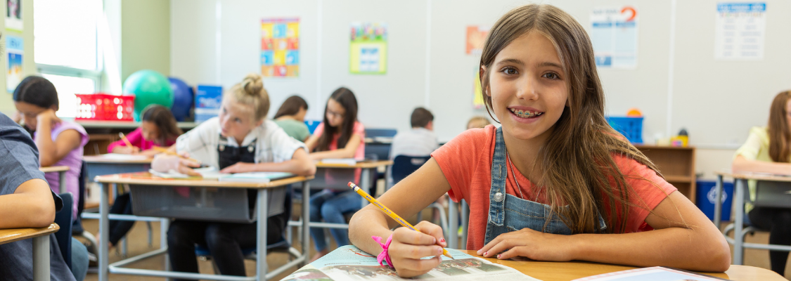 Girl at Desk w: SW Girl using Studies Weekly