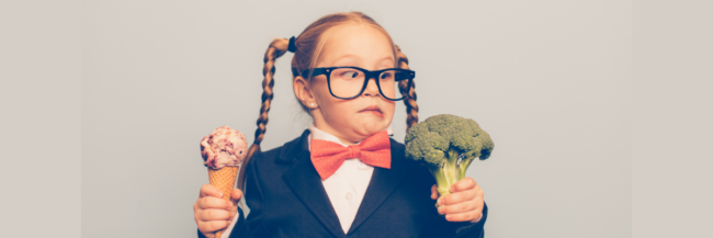 Cute little kid can't decide between broccoli or ice cream.