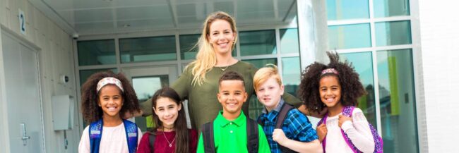 Class smiling together with teacher