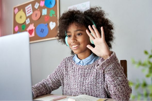 Student waving at their teacher during virtual end-of-year celebration.