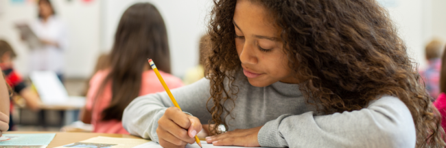 Student working Studies Weekly Student writing