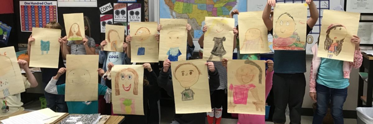 Children-holding-up-pictures Sandra Bradshaw's second grade class