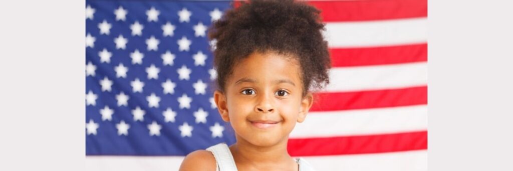 Student-with-American-Flag-November-2025 Child in Front of American Flag