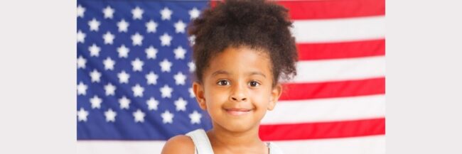Student-with-American-Flag-November-2025 Child in Front of American Flag