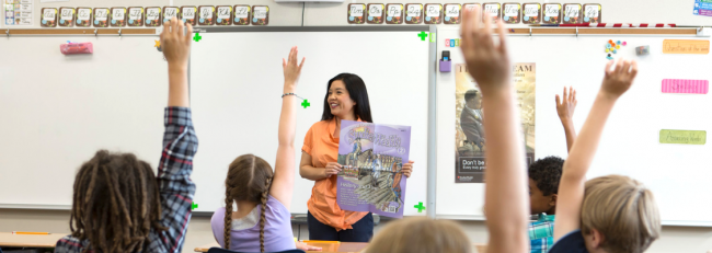Teacher with Studies Weekly in summer school class.