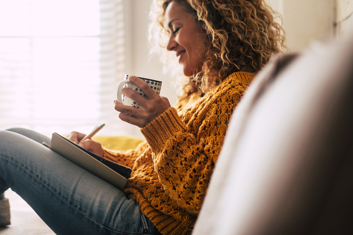 Woman Drinking Coffee and Writing in Journal Woman Drinking Coffee and Writing in Journal