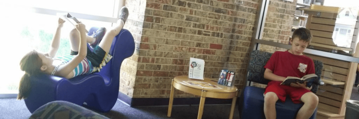 Susan Cro's grandchildren read books recommended by Studies Weekly at their local library.