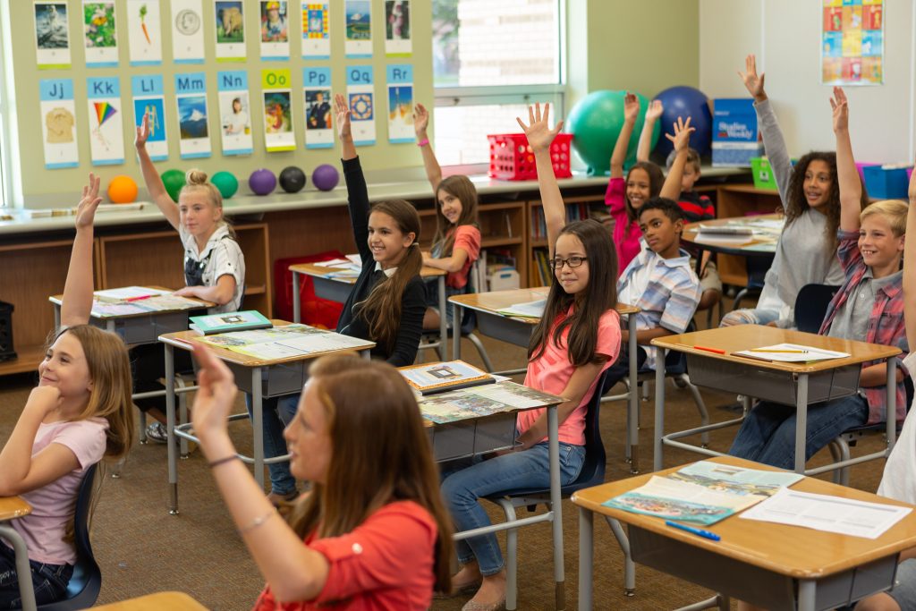 Students-raising-their-hands Studies Weekly Students raising hands