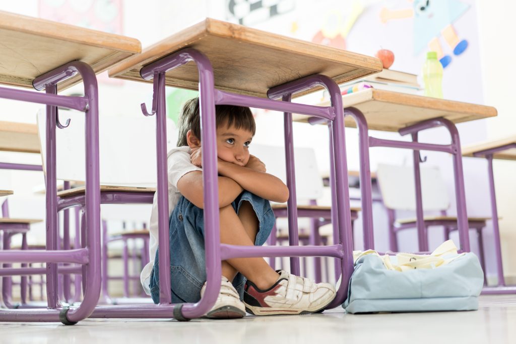Shy kid hiding under table Child Feeling Anxiety
