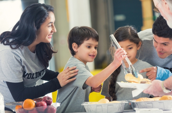 Children volunteering in soup kitchen as part of civic engagement.