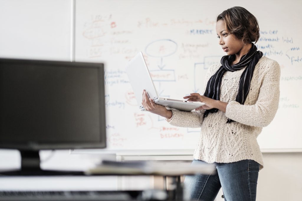 Businesswoman using laptop School leader using data to drive class decisions
