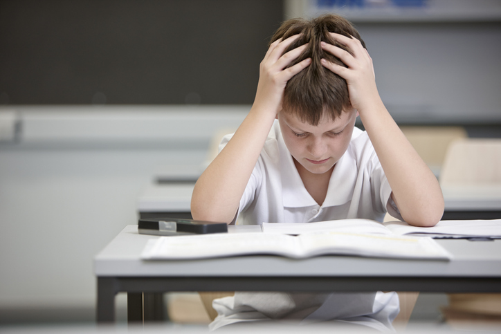 Schoolboy struggling in educational exam Boy struggling with negative emotions and negative self-talk