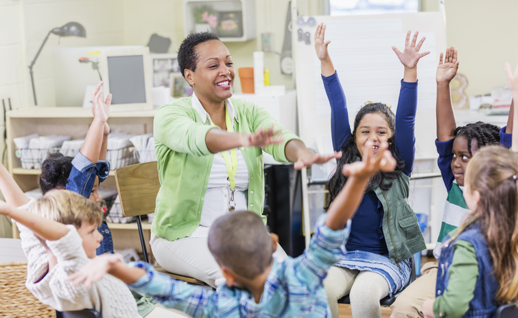 African-American teacher, young children in class Teacher leads students in exercise to deal with negative emotions