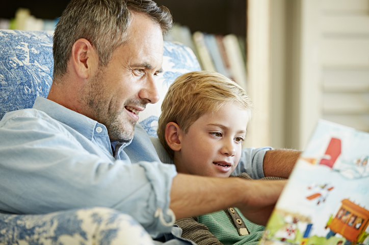 Parent getting involved in summer school learning by reading to their child