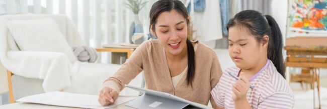 Teacher helping an autistic student