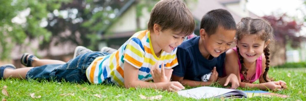 Kids-Reading-in-Park-October-2025 Design an Effective Summer school program for elementary students
