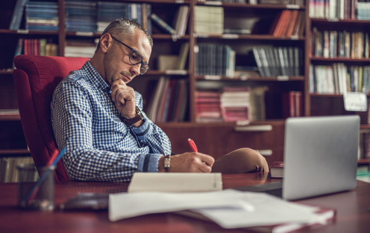 Male manager taking notes in home office. Male manager taking notes in home office.