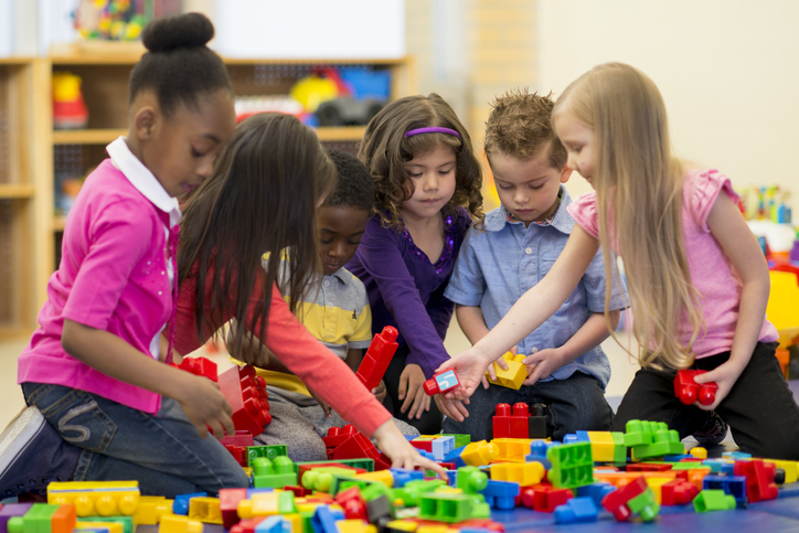 Students do a Studies Weekly Extended Learning Curriculum activity with plastic blocks to practice English Language Arts