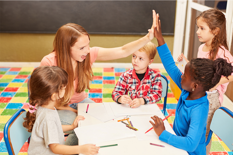 Teacher supporting children