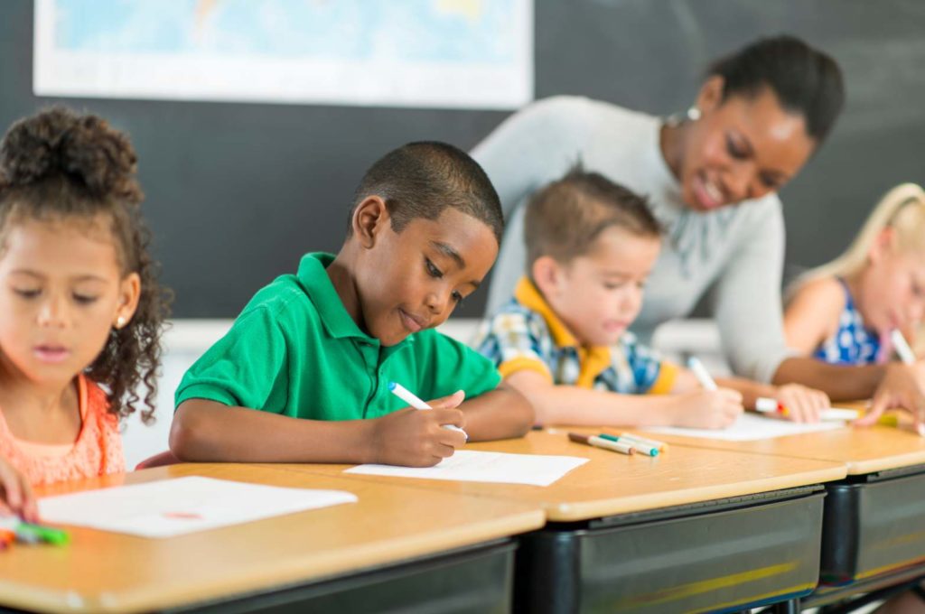 Elementary students writing Elementary students writing