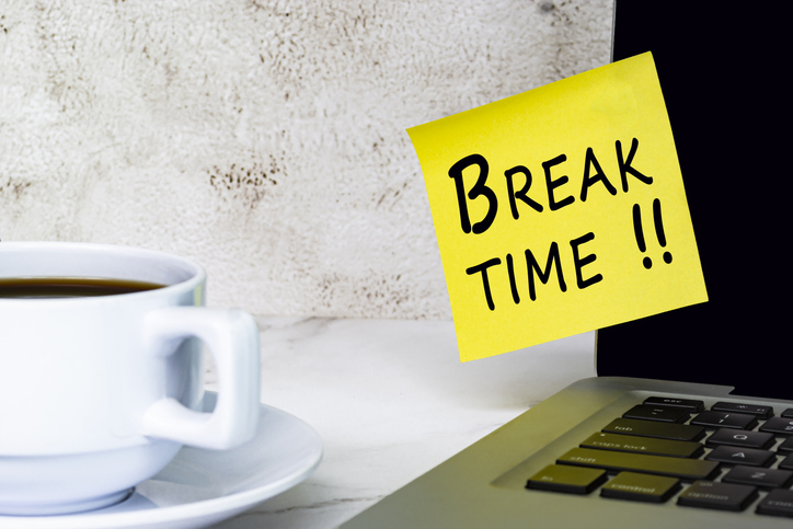 Break time text on a yellow sticky note at the office. Break time text on a yellow sticky note stuck on a computer screen.