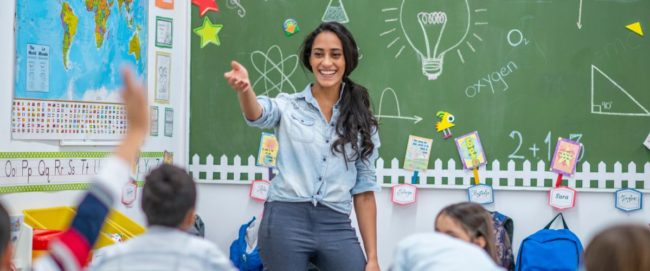 Science Teacher Science teacher standing in front of the classroom and engaging with students