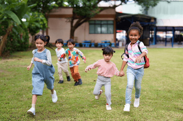 Group of children enjoy running and playing in the field