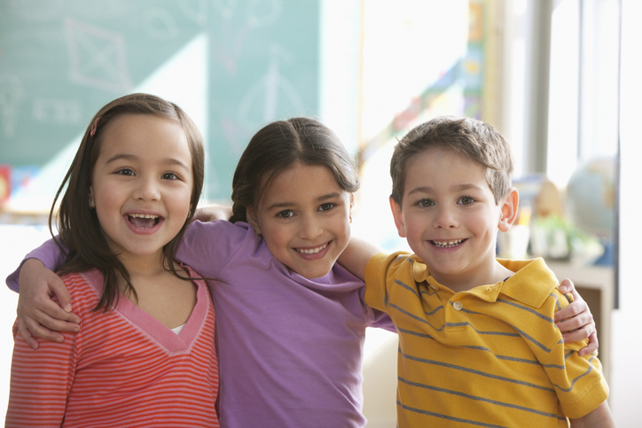 Students standing together in classroom