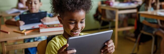 Child-on-tablet Student reading online on a tablet