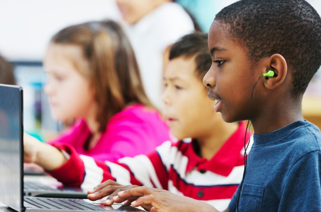 Boys using computers in class
