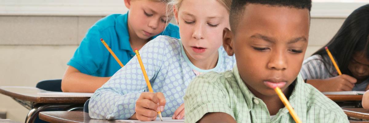Students-taking-a-test Students sitting at desks taking a test in class