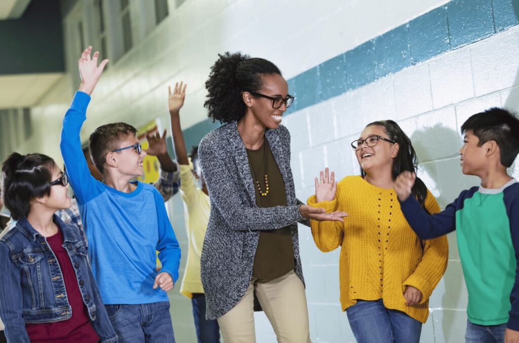 Teacher greeting students