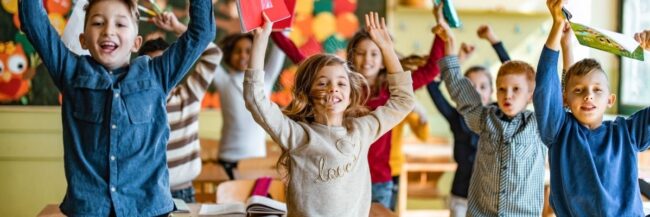 Children practicing behavior management through stretching and moving