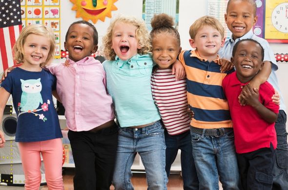 Happy class of students with arms around each other