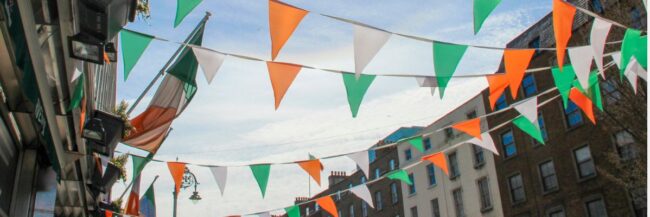 Irish-Flags-Blog-Header-1200-x-400-px View of many Irish flags