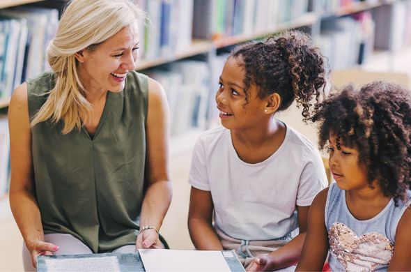 Teacher with children visiting the library