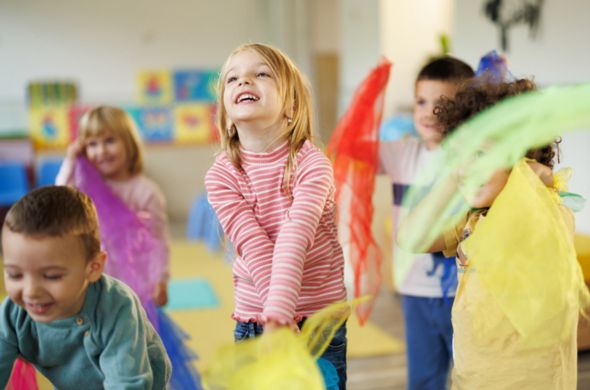 Children managing behaviors by playing with tulle and dancing