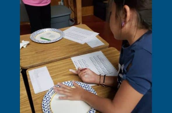 Kristin Wolfgang’s students making cuneiform letters in air drying clay.