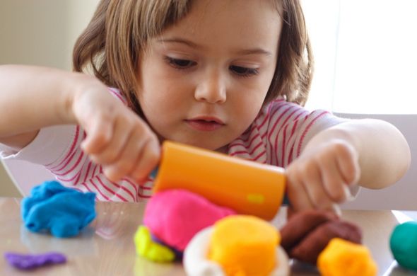 Little girl playing with playdough