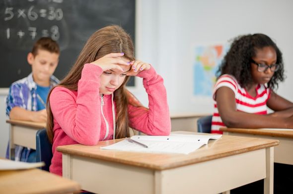 Student looking frustrated working on homework
