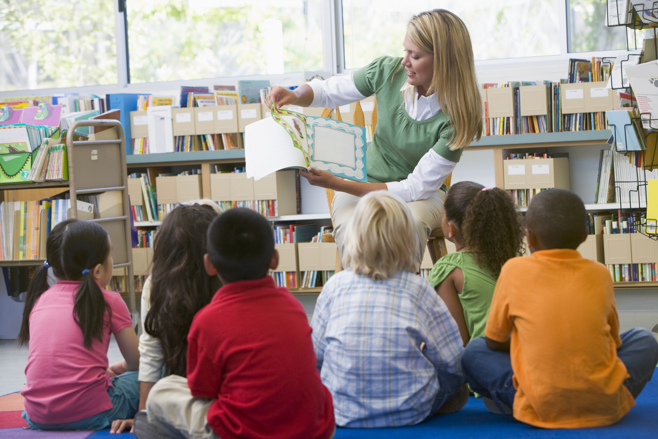 teacher reading aloud to children