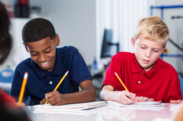 Students writing in gratitude journals