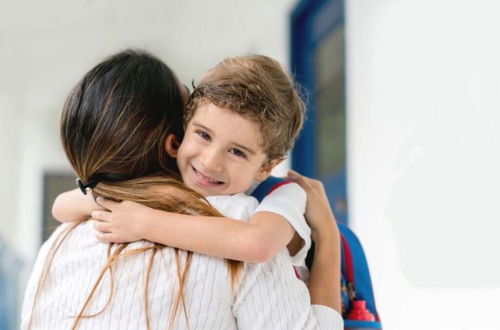 Student giving teacher a hug