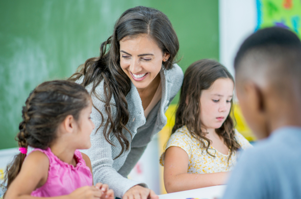 Happy teacher Happy new teacher working with students