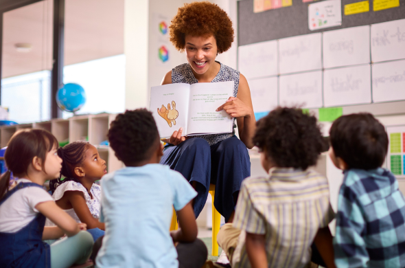 Teacher reading aloud Teacher holding book and reading aloud to students to reinforce science of reading