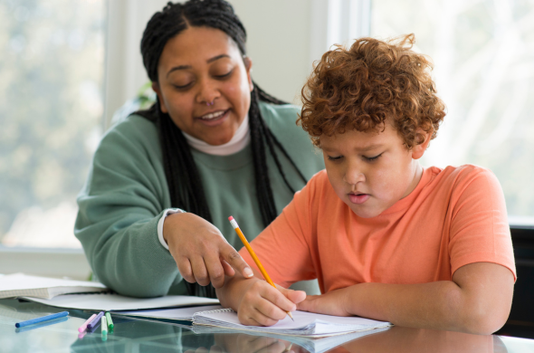Teacher working with student New teacher working 1-on-1 with student on school work