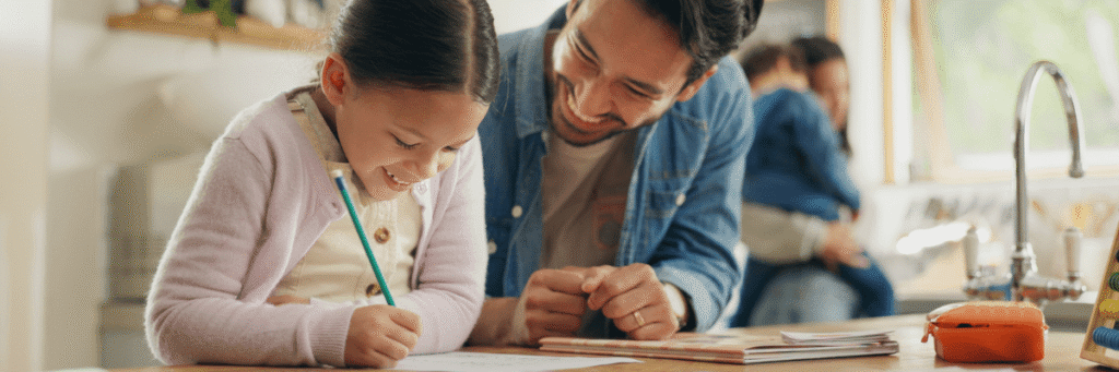 Parent and student doing homework Parent and student sitting at a desk doing homework together