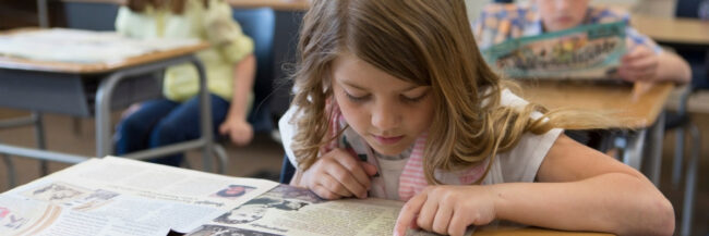 Student with Studies Weekly Print 1200×400 Header