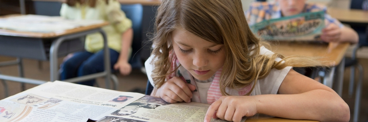 Student with Studies Weekly Print 1200×400 Header