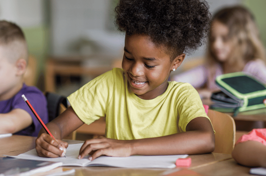 Little girl writing in a notebook